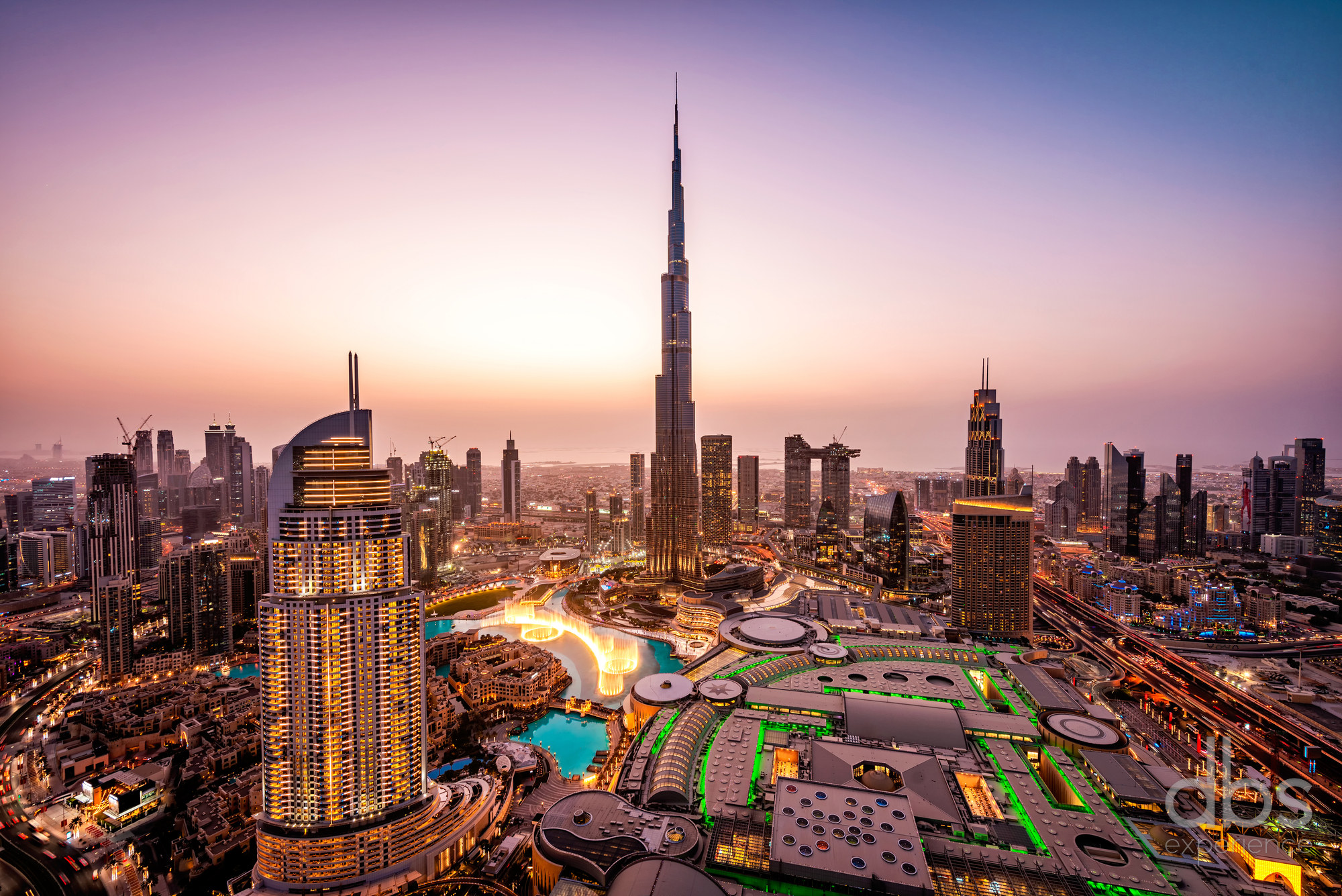 Downtown Dubai at dusk with the Burj Khalifa rising above the city lights