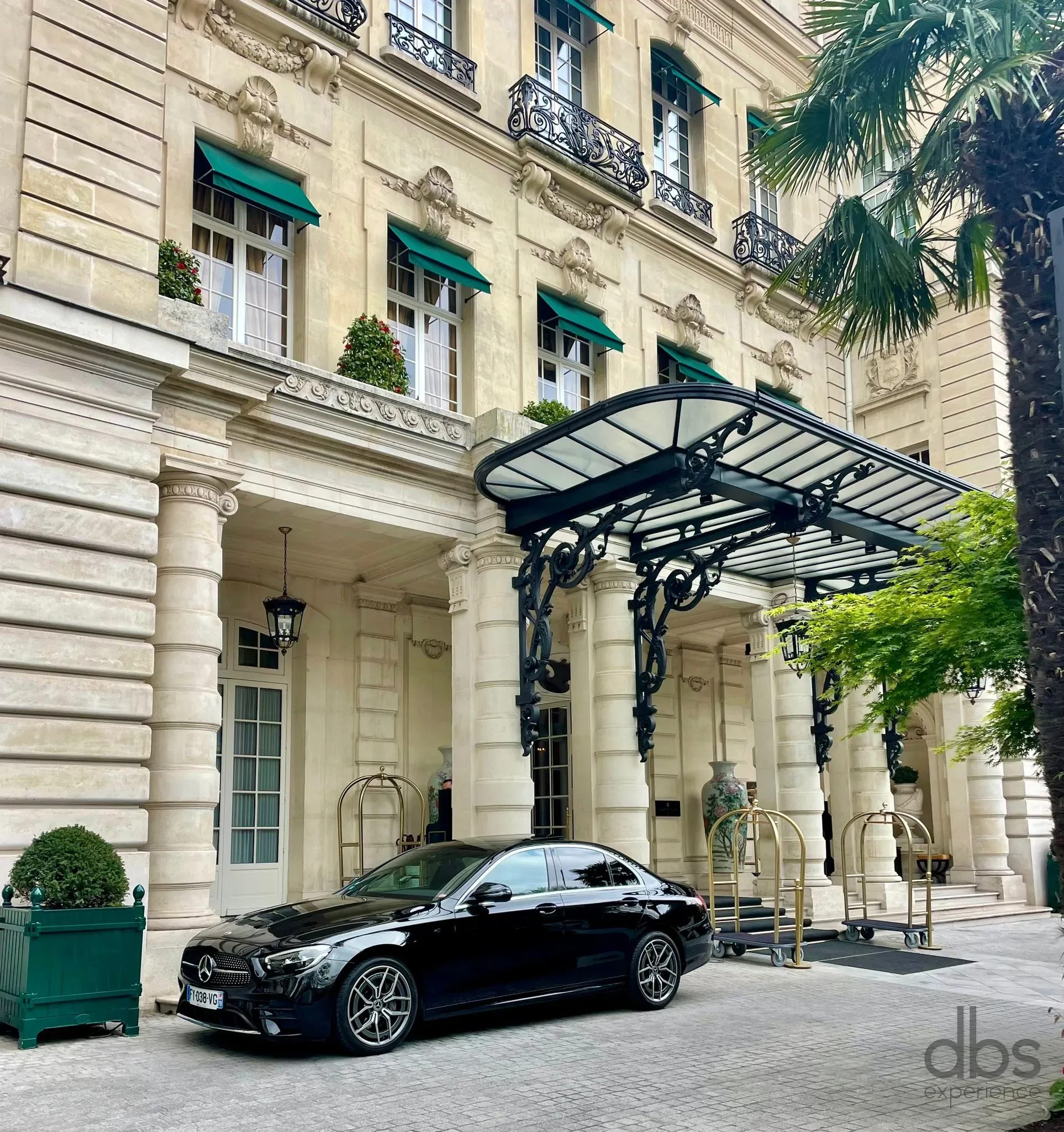 A DBS EXPERIENCE chauffeur welcoming a guest at a Paris hotel