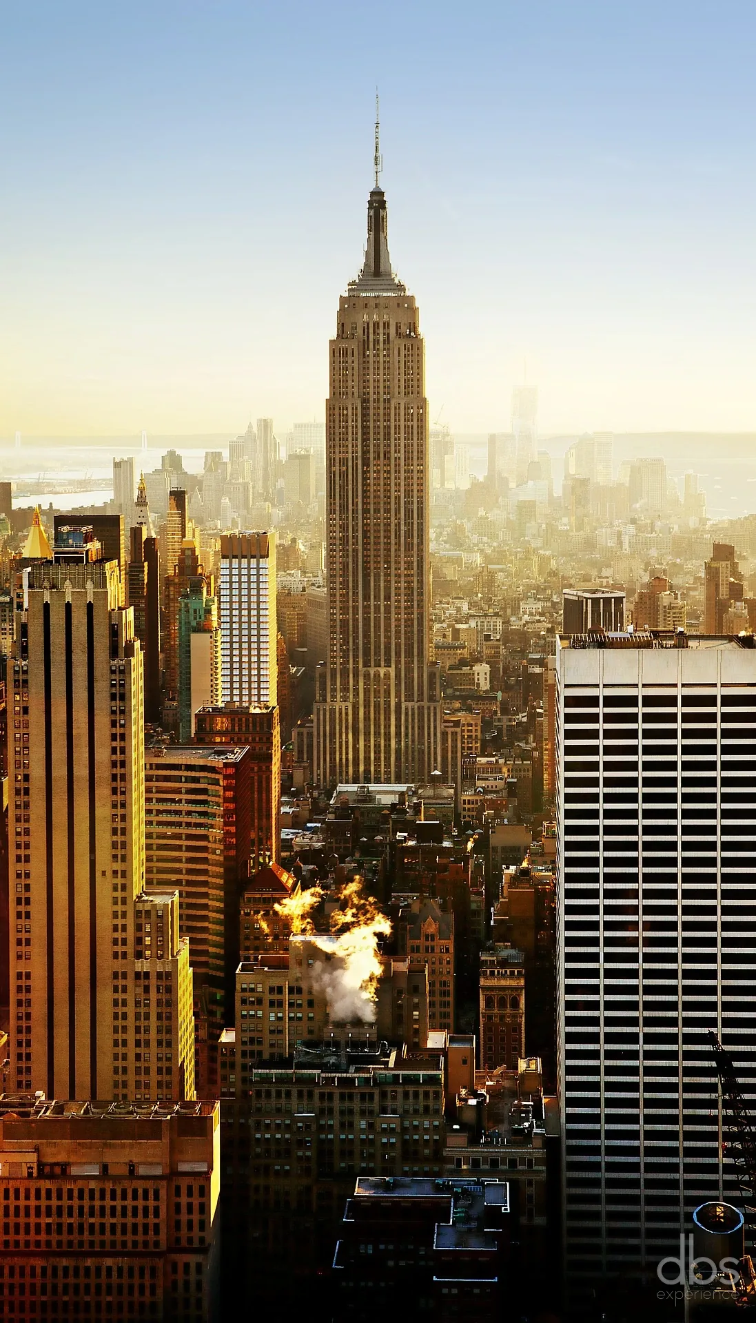 The Empire State Building rising above the Manhattan skyline in golden light