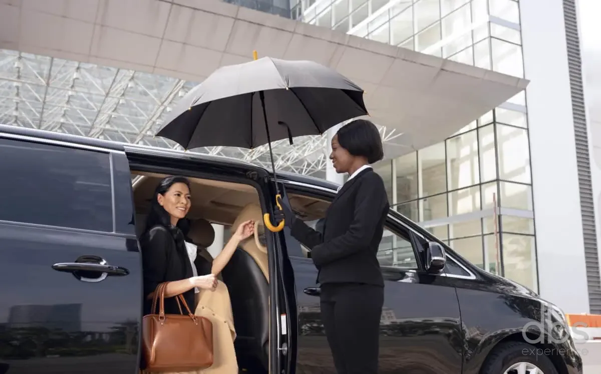 A guest stepping into a chauffeured car in Paris
