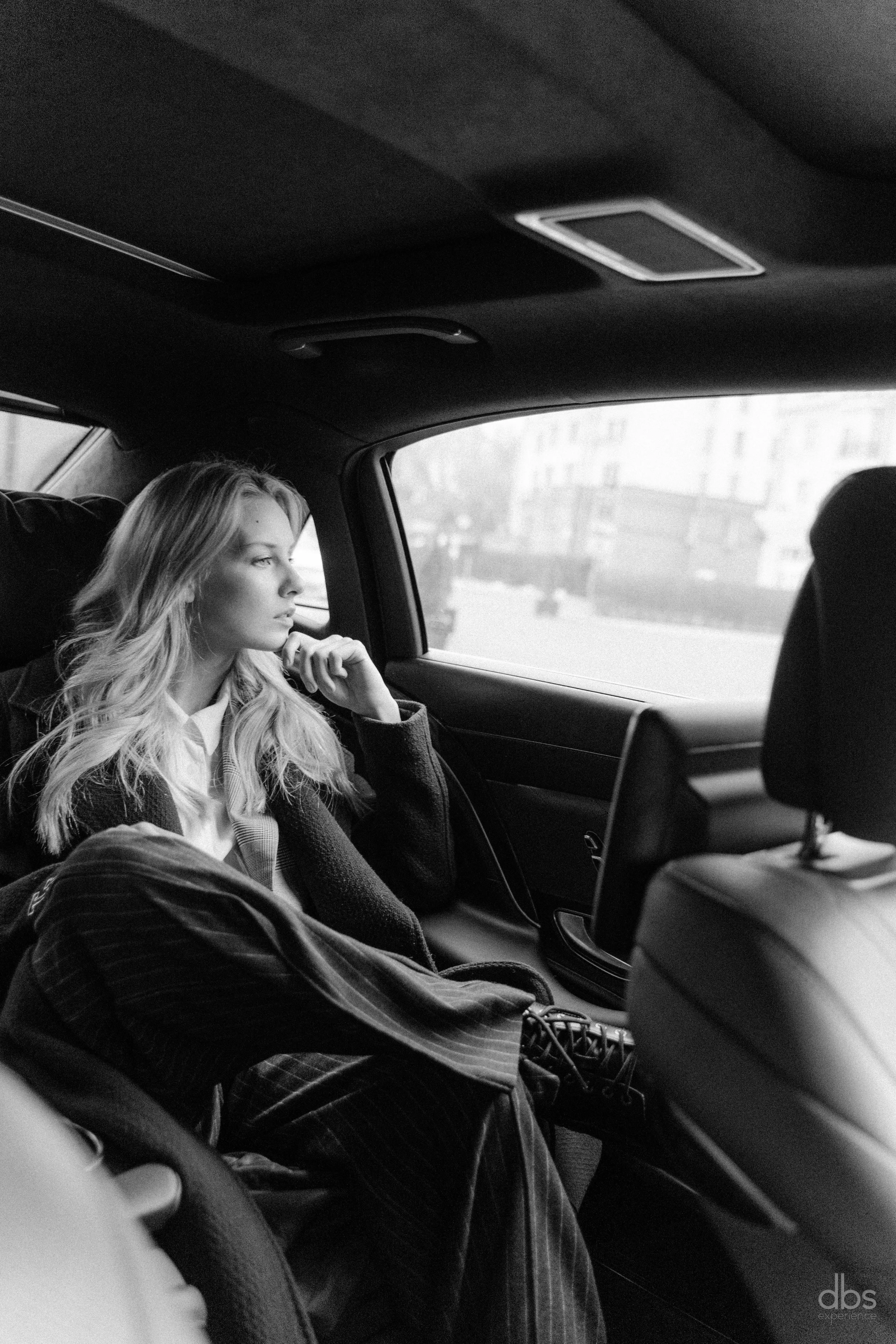 An executive seated in the back of a chauffeur-driven car after a Paris airport meet and greet