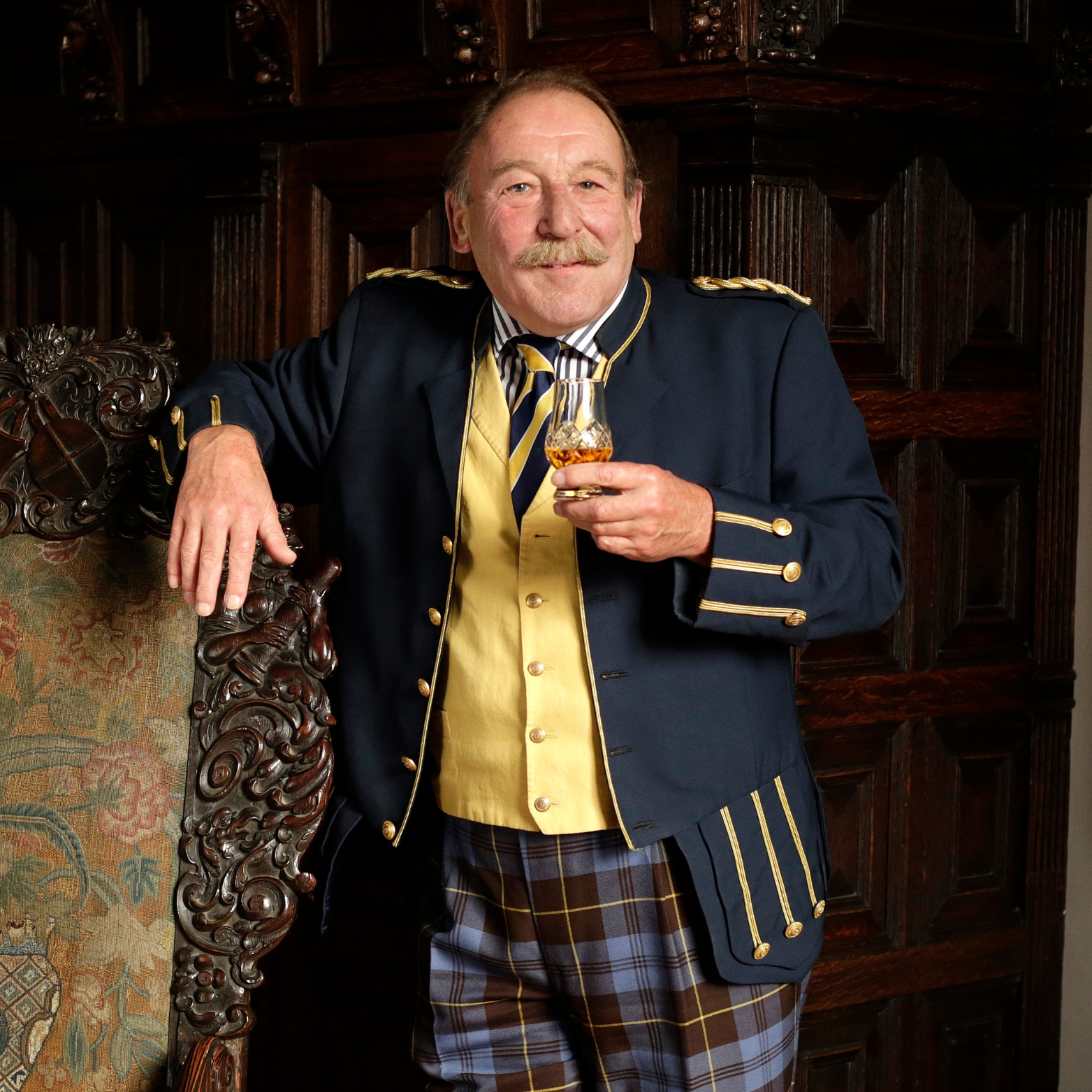 Charles MacLean MBE with a glass of whisky