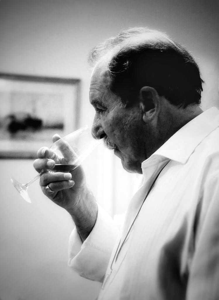 Charles MacLean MBE nosing a glass of whisky