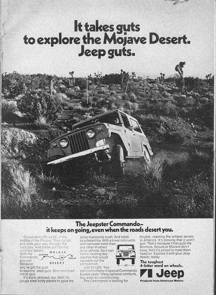 A vintage advertisement shows a white Jeep driving up a rugged, rocky hill in the Mojave Desert, surrounded by desert plants and text promoting the Jeepster Commandos toughness and off-road capabilities.