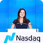 Woman with long dark hair smiling at a Nasdaq podium on blue background.