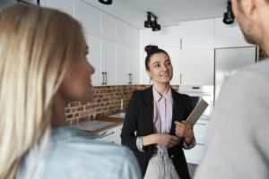 Real Estate Agent Showing New Apartment To A Couple