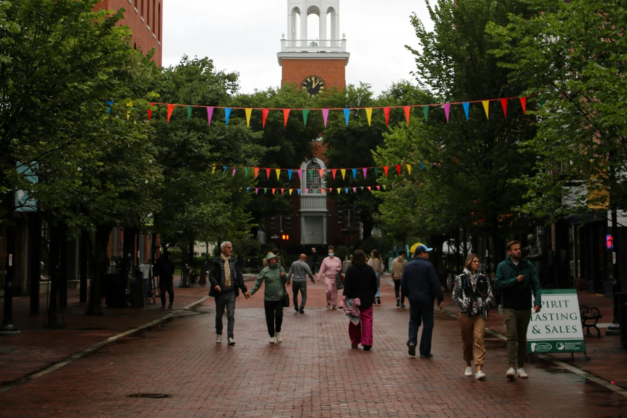 Residents and tourists walk on a crowded street in Burlington, Vermont