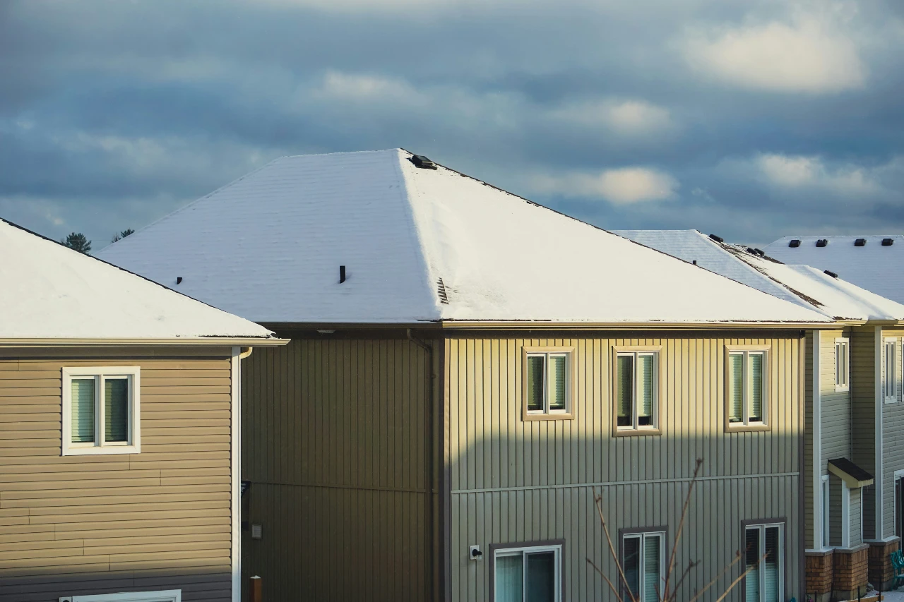 A snowy roof on a rental property