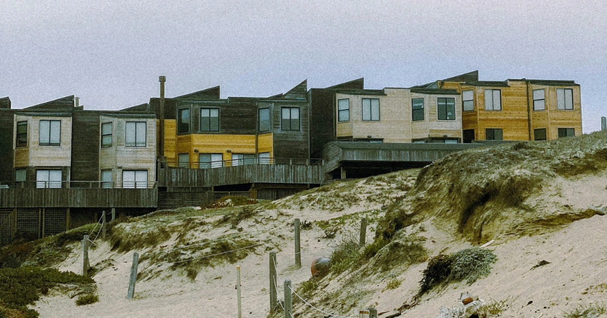 A series of coastal houses near a beach