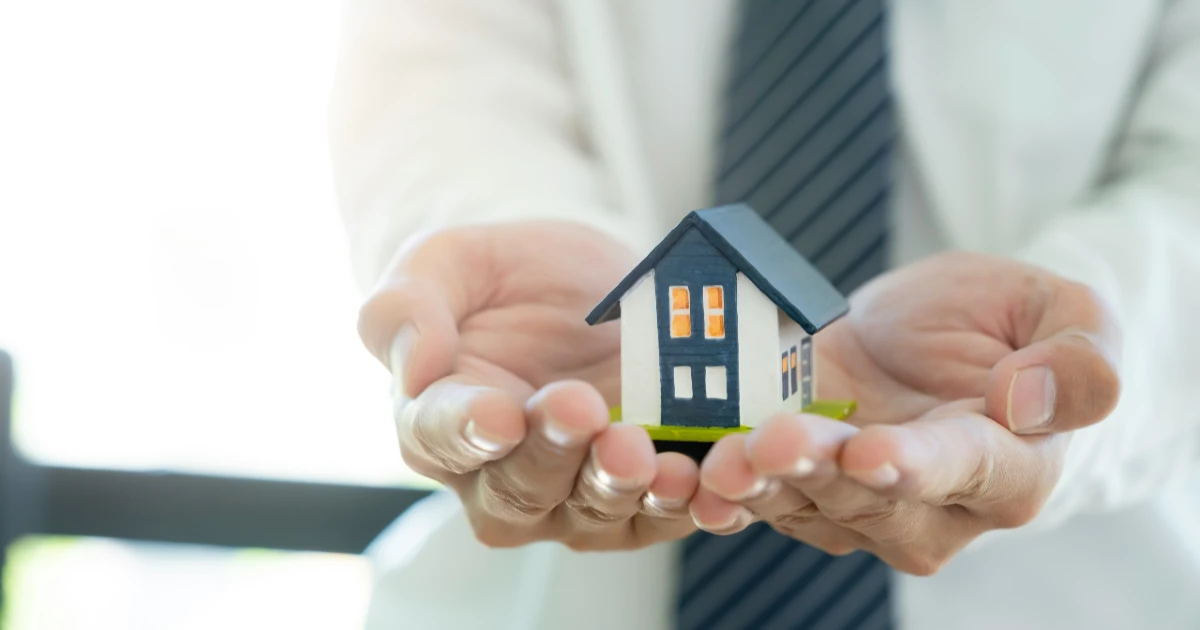 A man holds a tiny home