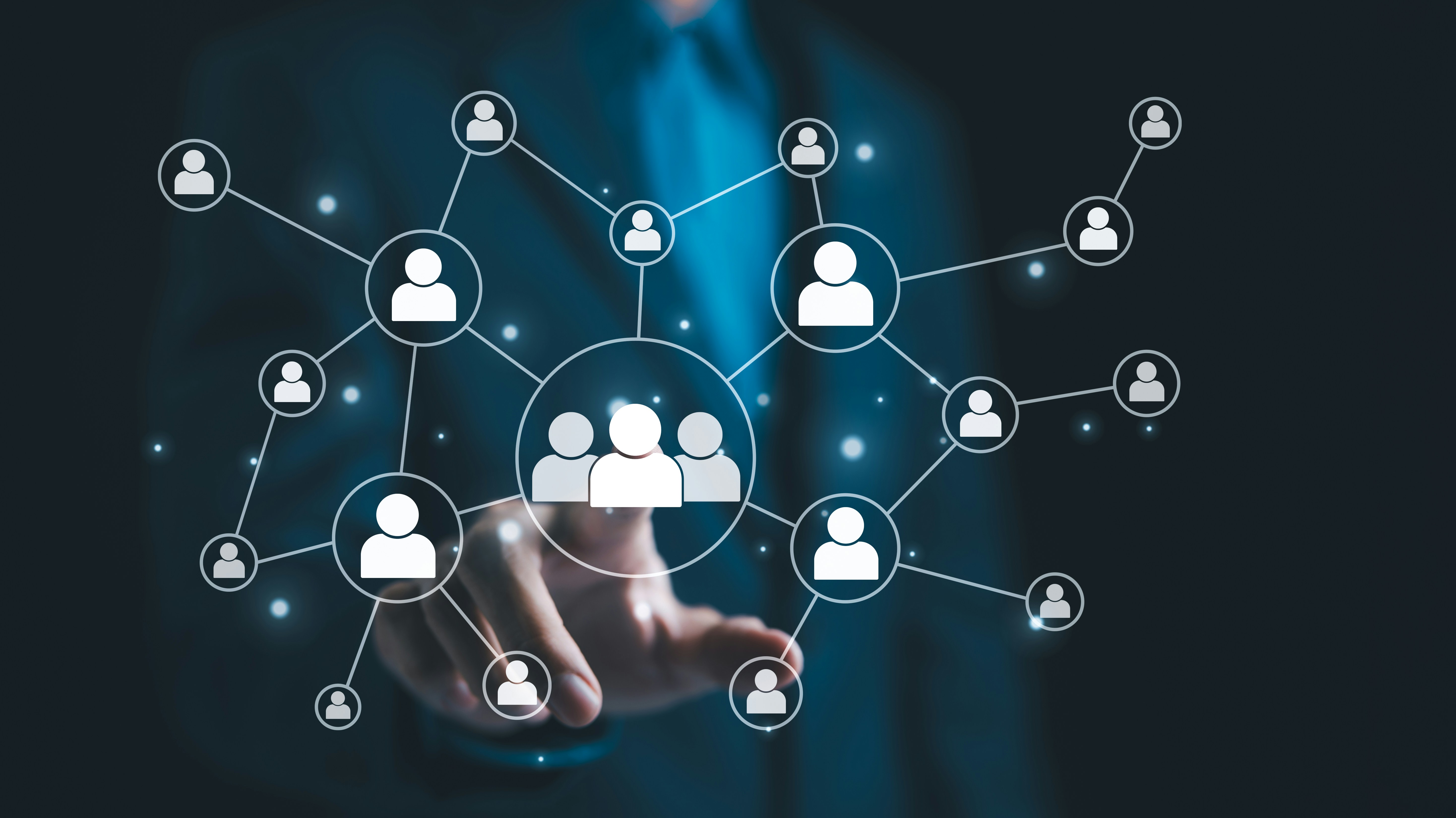 Businessman touching a network of connected referral icons, representing partner referral links