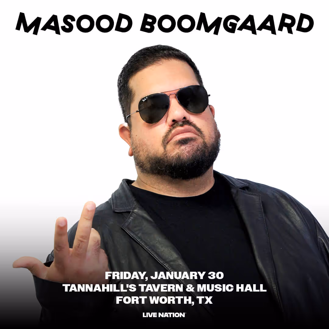 Masood Boomgaard wearing sunglasses and a black leather jacket posing with a hand gesture for event at Tannahill's Tavern & Music Hall, Fort Worth, TX.