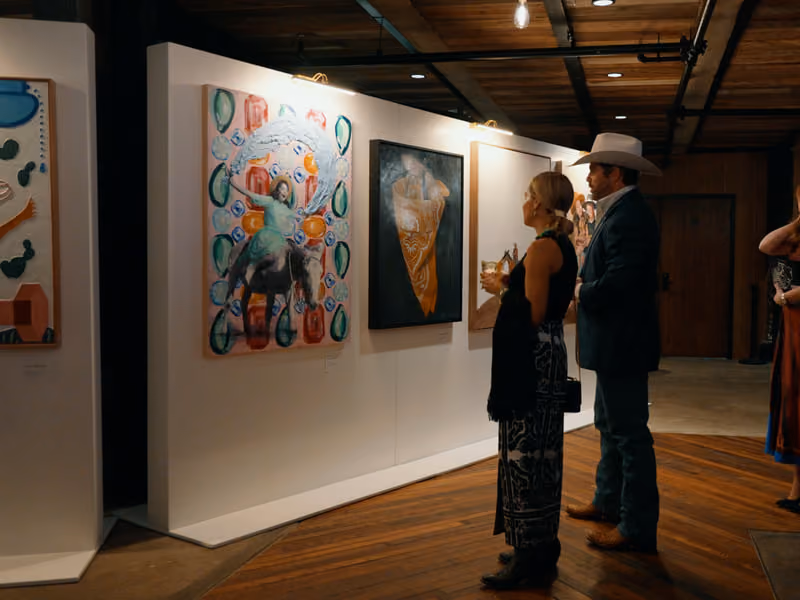 Guests in cocktail attire viewing an art installation in a Tannahill's event space