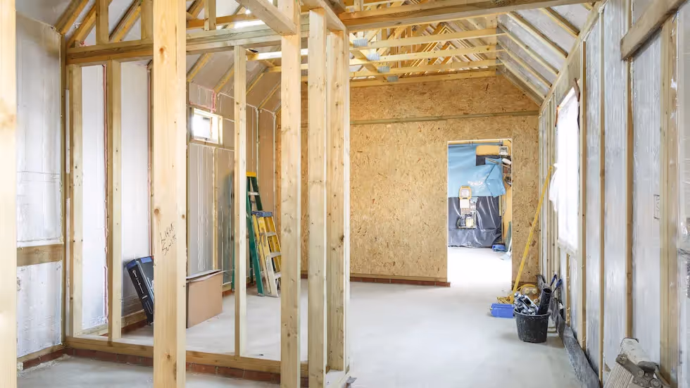 Timber frame construction of a residential home extension in progress.