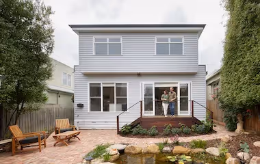 Couple outside a newly renovated two-storey home