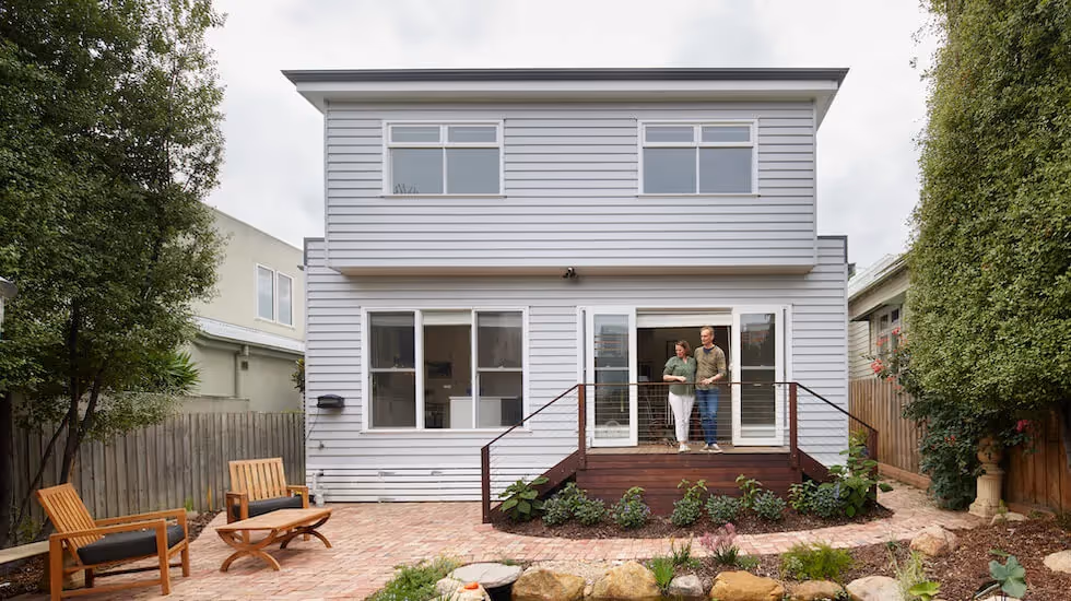 Couple outside a newly renovated two-storey home