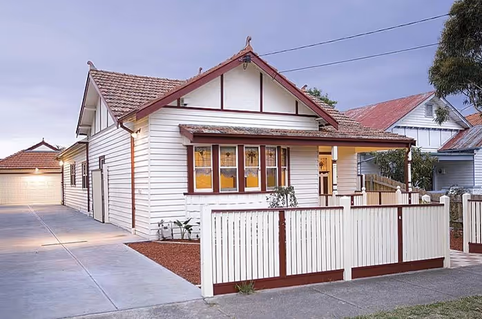 Single-storey brick house with tiled roof and front porch.