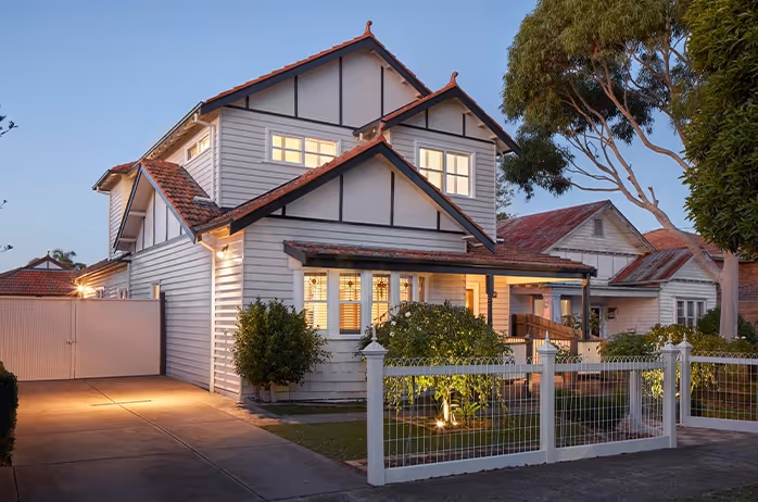 Single-storey brick house with tiled roof and front porch.