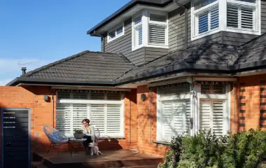 Two-storey brick home with a modern weatherboard extension.