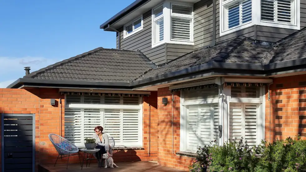 Two-storey brick home with a modern weatherboard extension.