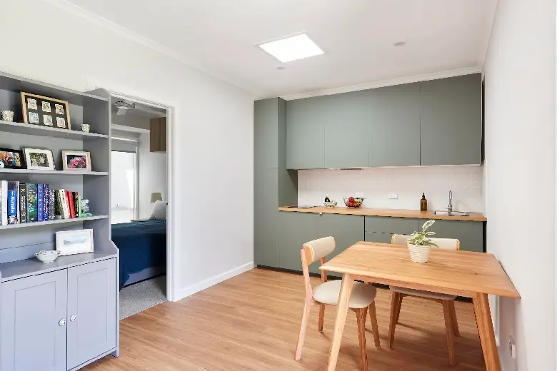 Compact modern home extension interior with kitchenette.