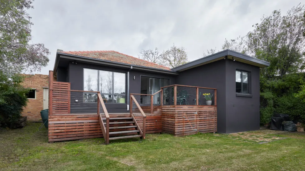 Ground floor home extension renovation in Melbourne featuring a timber deck and outdoor stairs.