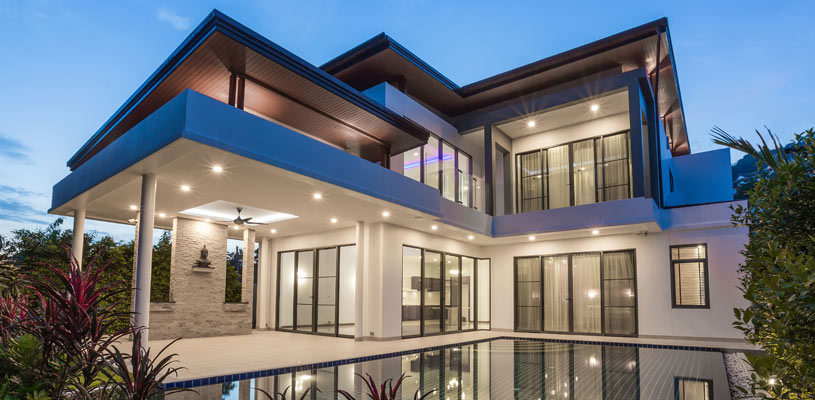 Contemporary double-storey home extension with large windows and outdoor entertaining space.