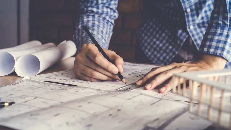 Architect and builder reviewing architectural plans for a custom home extension and renovation project.