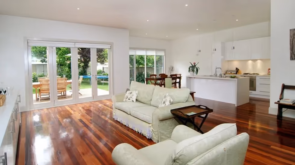 Bright open-plan living room and modern kitchen in a completed Supa Group home extension.