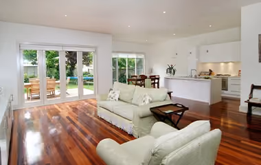 Bright open-plan living room and modern kitchen in a completed Supa Group home extension.