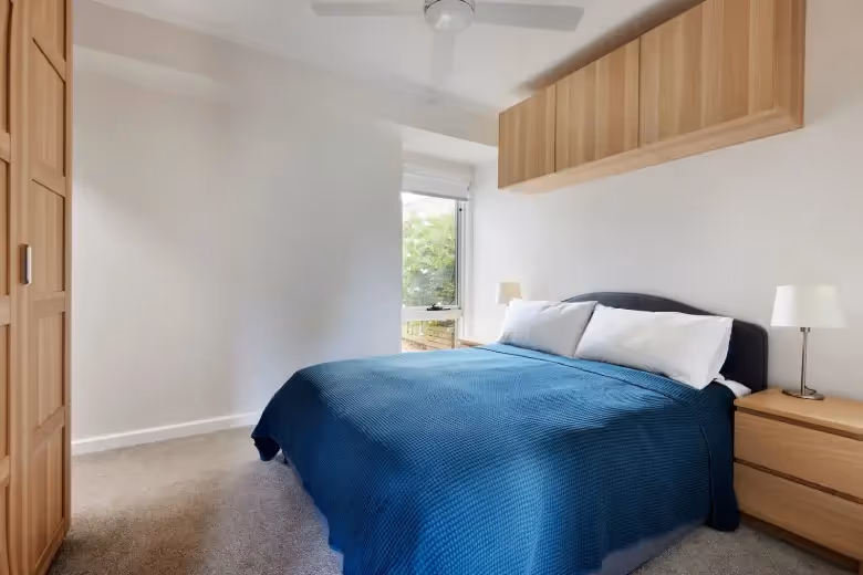 Comfortable bedroom with built-in storage created as part of a modern home extension.