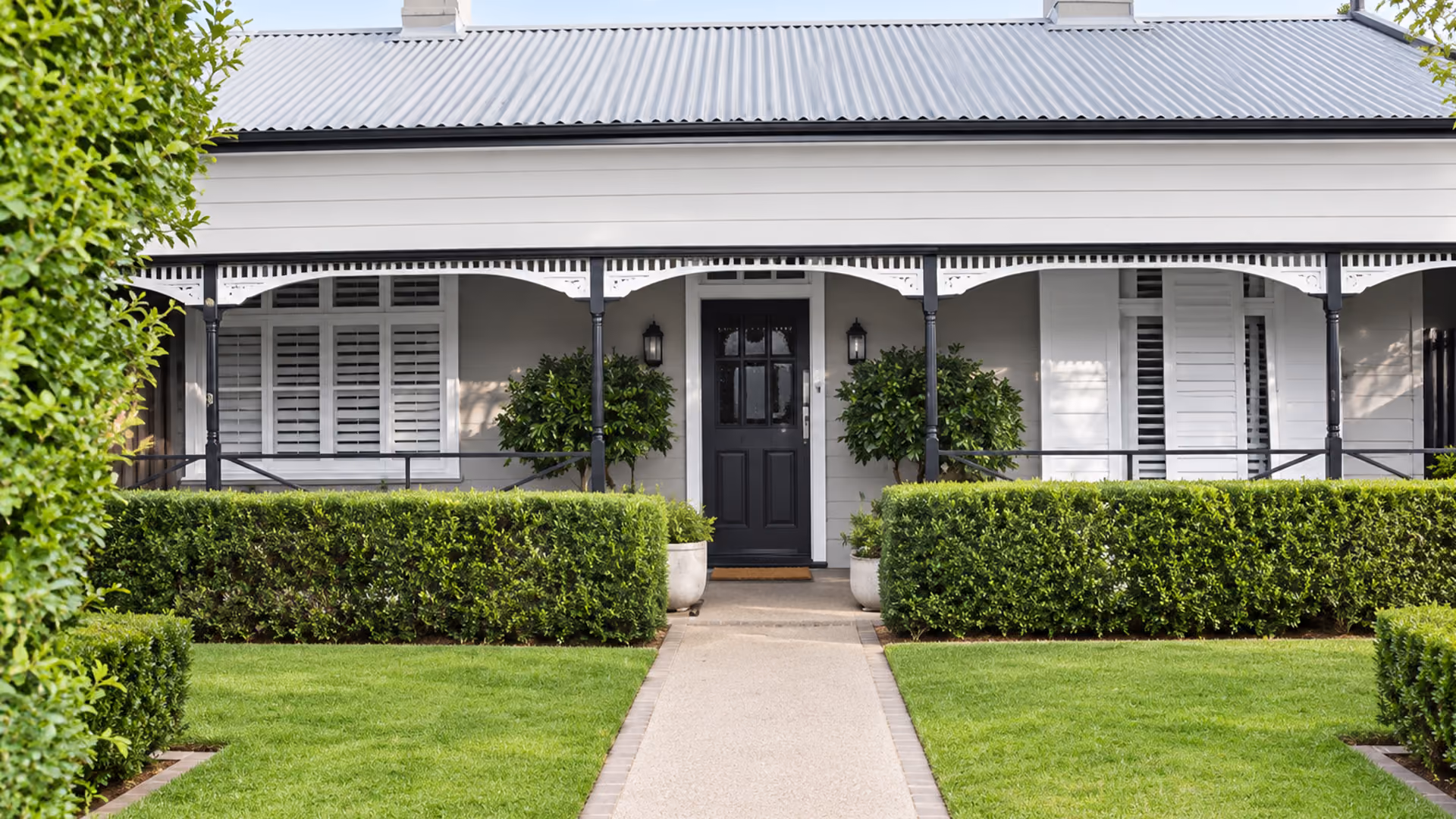 A restored Victorian weatherboard home in Brunswick with a front garden and traditional verandah.