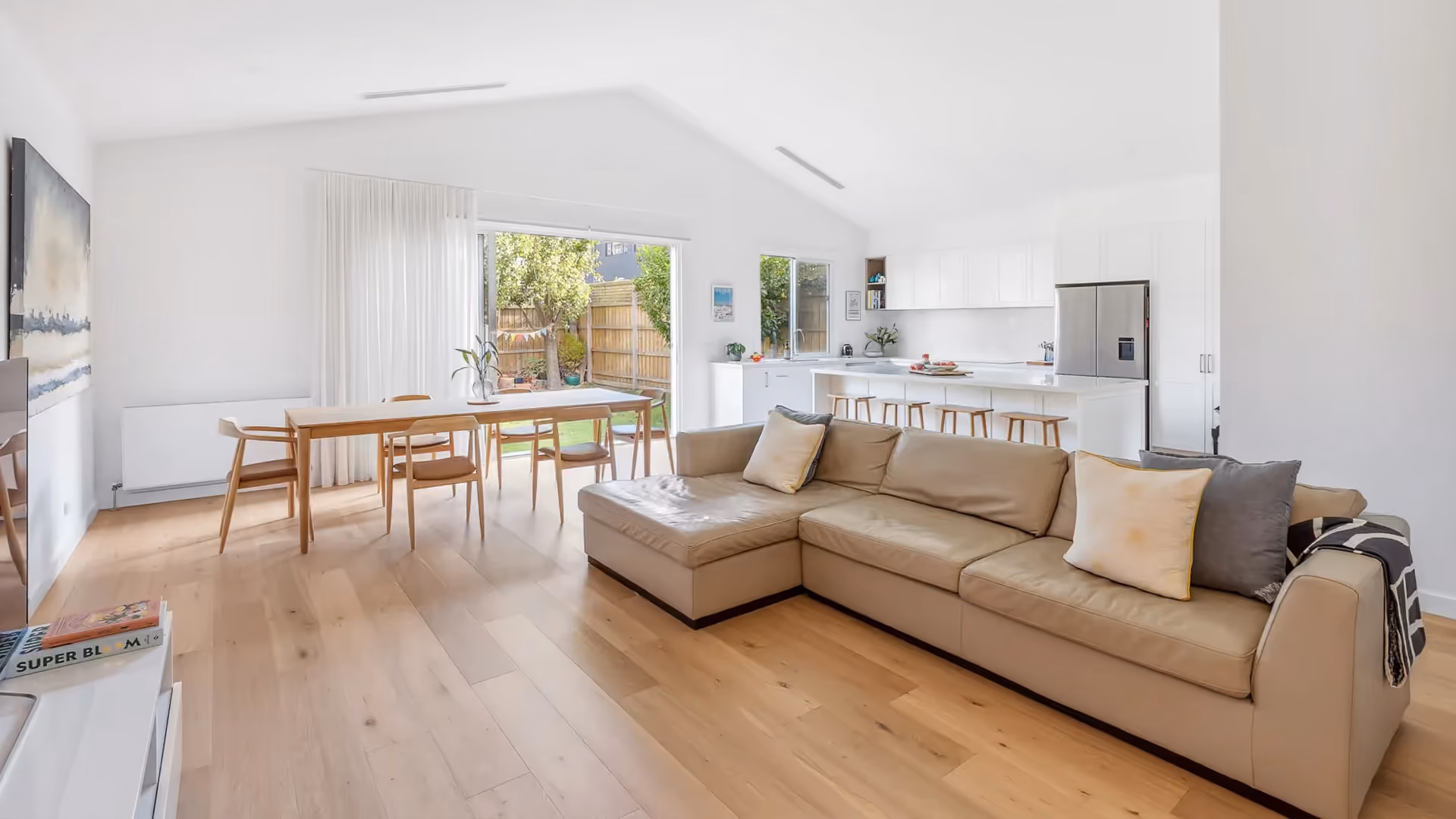 Bright open-plan kitchen, dining and living area in a renovated family home.