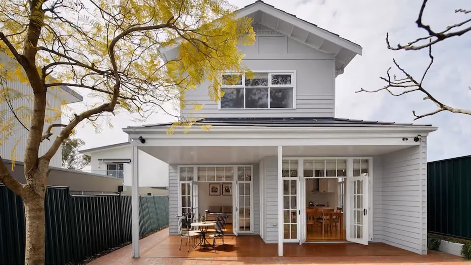 Rear view of a two-storey home extension with covered outdoor entertaining area.