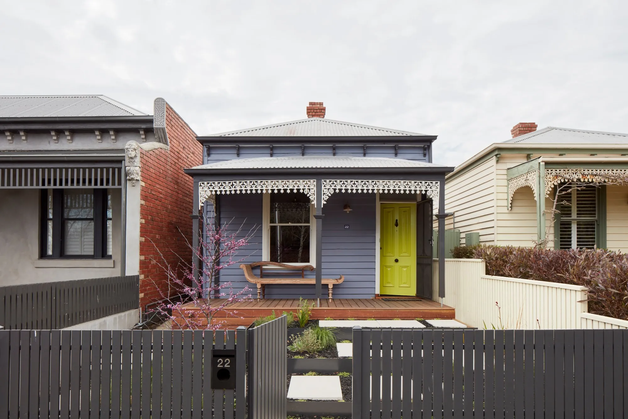 Built-in wooden shelving hallway with window seat and books.