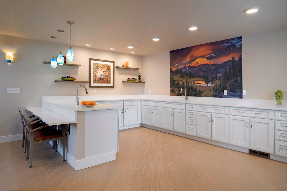 1 Bedroom Senior Apartments in Federal Way, WA | Federal Way | Kitchen Area with White Cabinets, Sinks, Spacious Counter Space, Breakfast Bar with Seating, and Pendant Lights