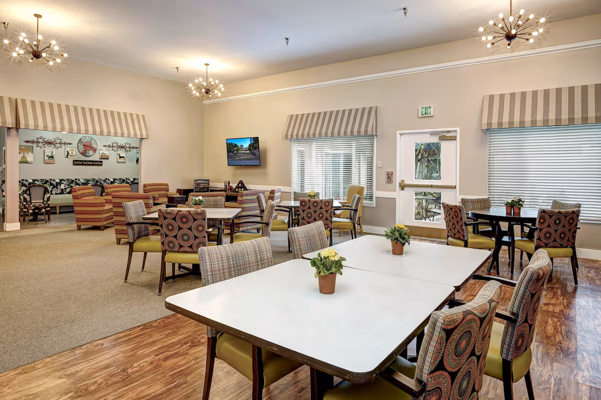 Lynnwood, WA Apartments - Lynnwood - Dining Area with White Tables, Carpeting, and High Ceilings