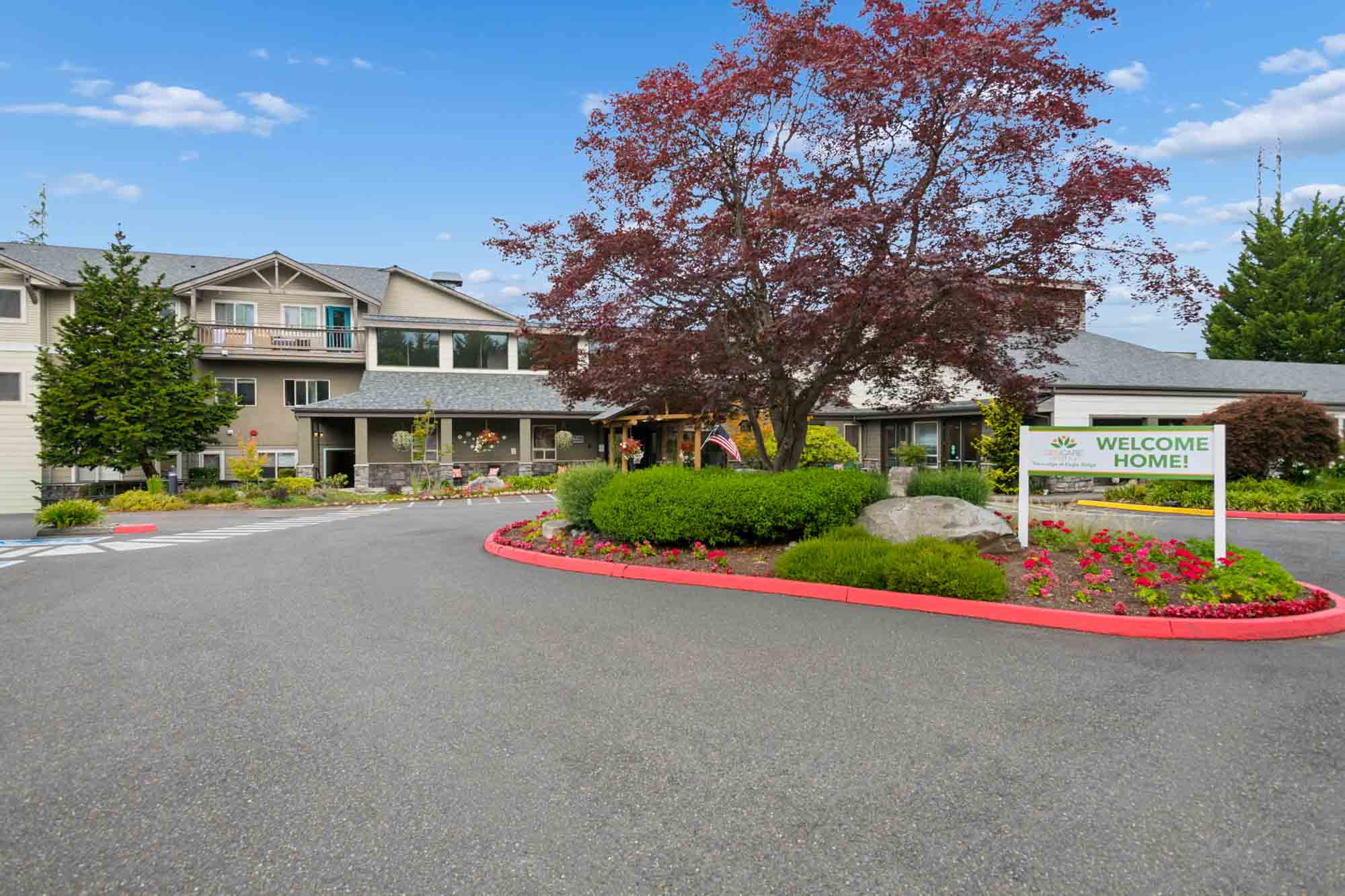  Apartments for Rent in Renton, WA - The Lodge at Eagle Ridge - Beautifully manicured garden with bushes, trees, walking path, and view of apartment homes.