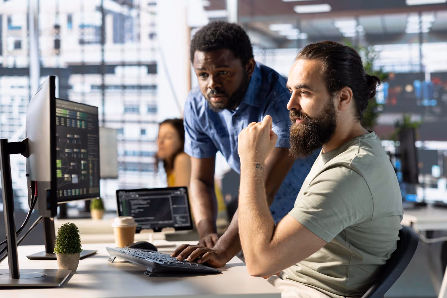 Programmer and colleague in office training machine learning algorithms