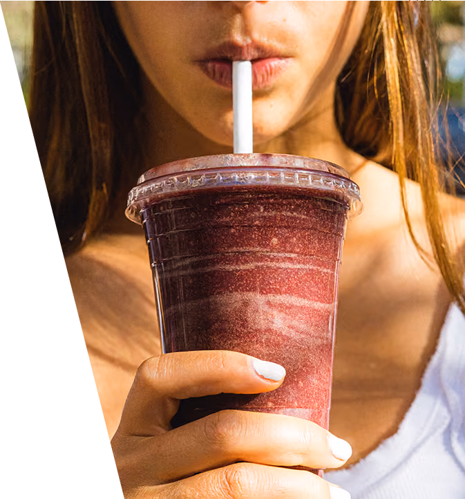 A girl sipping on an acai smoothie