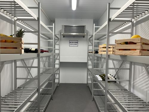 A look inside the container with shelves with wine and fruit