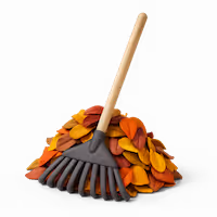 Leaf rake with wooden handles lying on a pile of red, orange and yellow leaves.