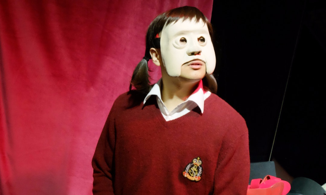 A person wearing a white mask. The mouth and chin are exposed.