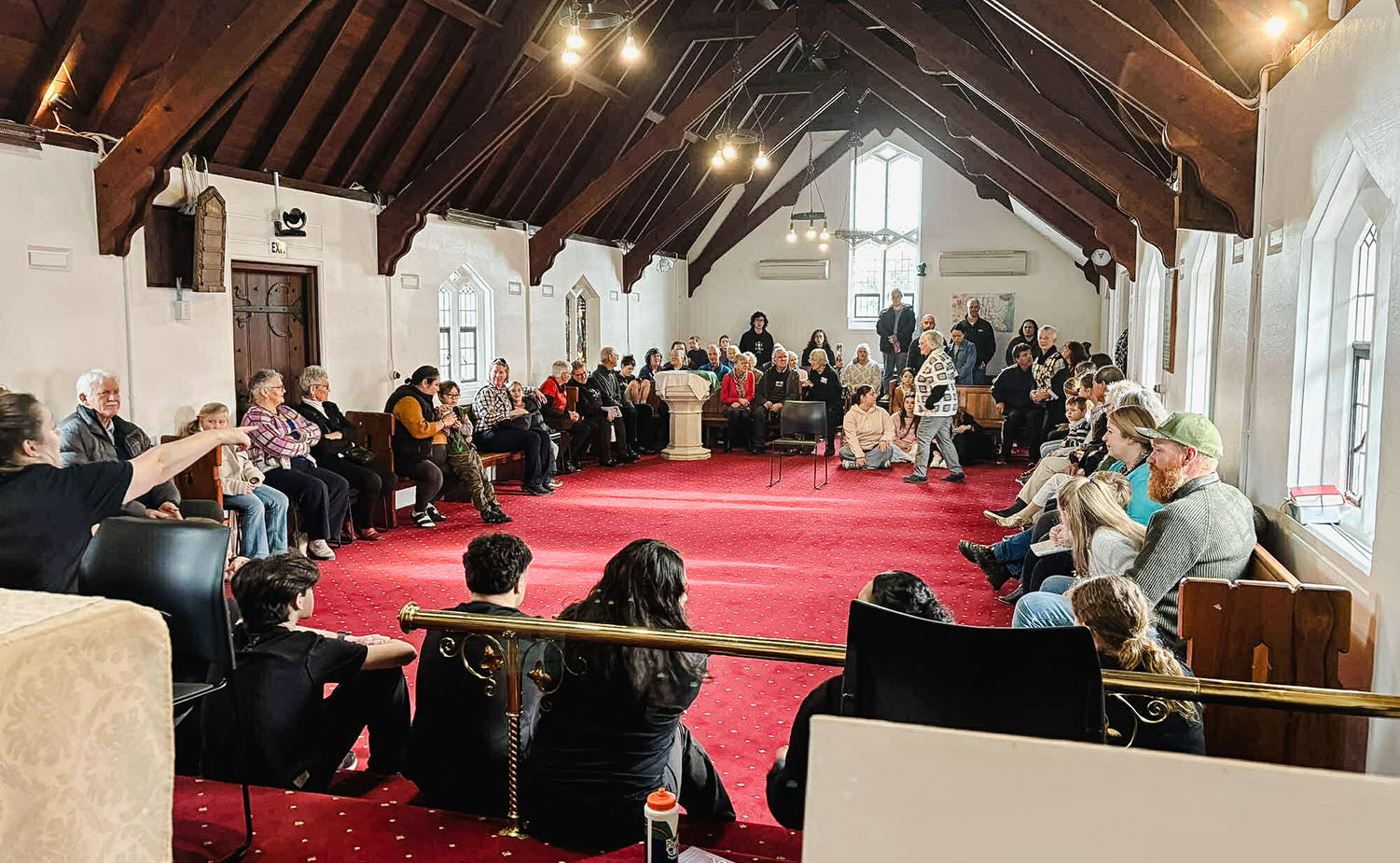 a crowd of people gathered in a church as part of Aptus, Anglican performing arts camp