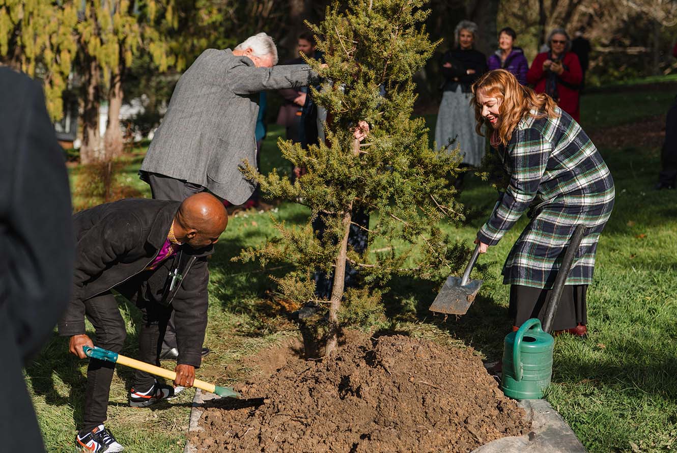 Bishop Steve and Rachel Boyack help to plant the tree