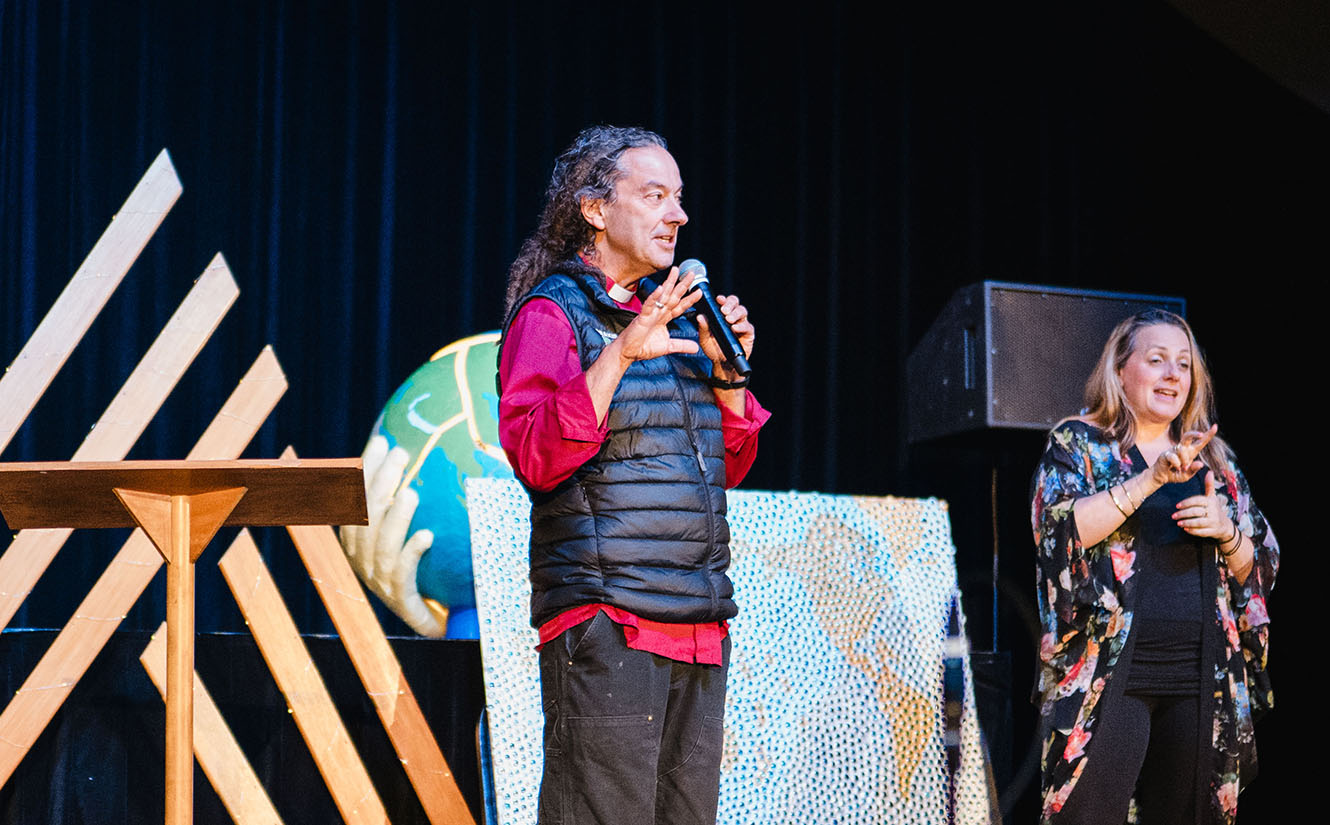 Archbishop Justin Duckworth speaks on stage