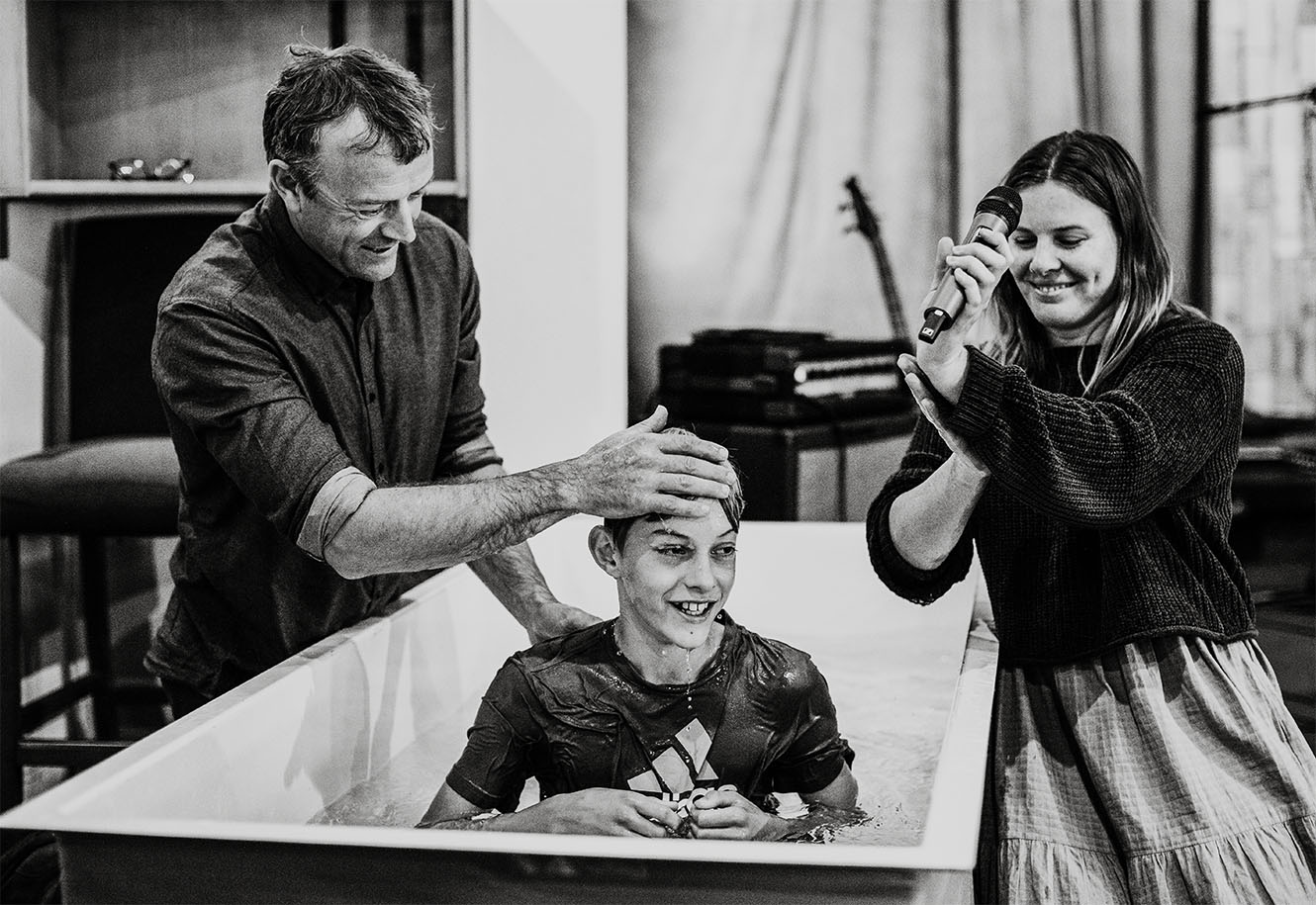 Rev Philip Greenwood and Georgia Armstrong baptise a boy