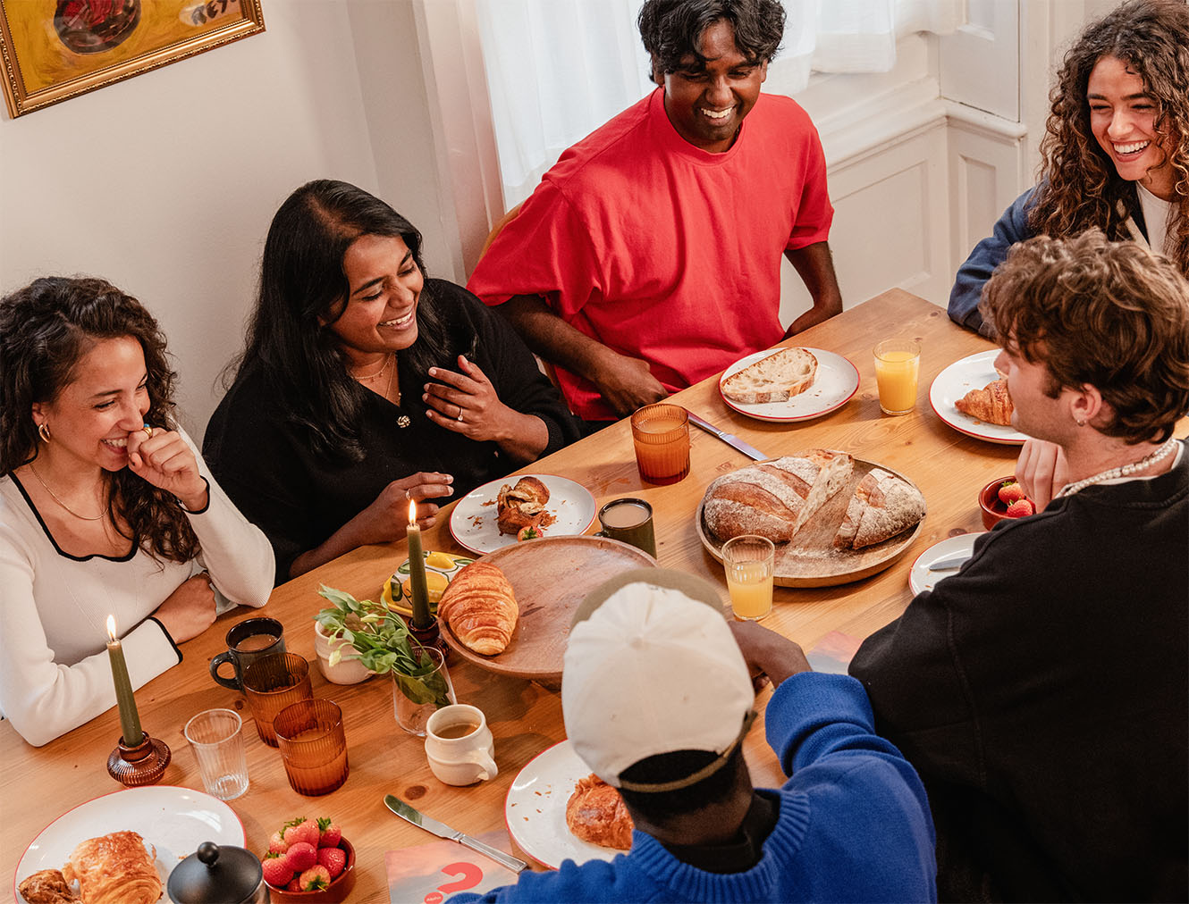 people sitting around a table enjoying a meal and conversation