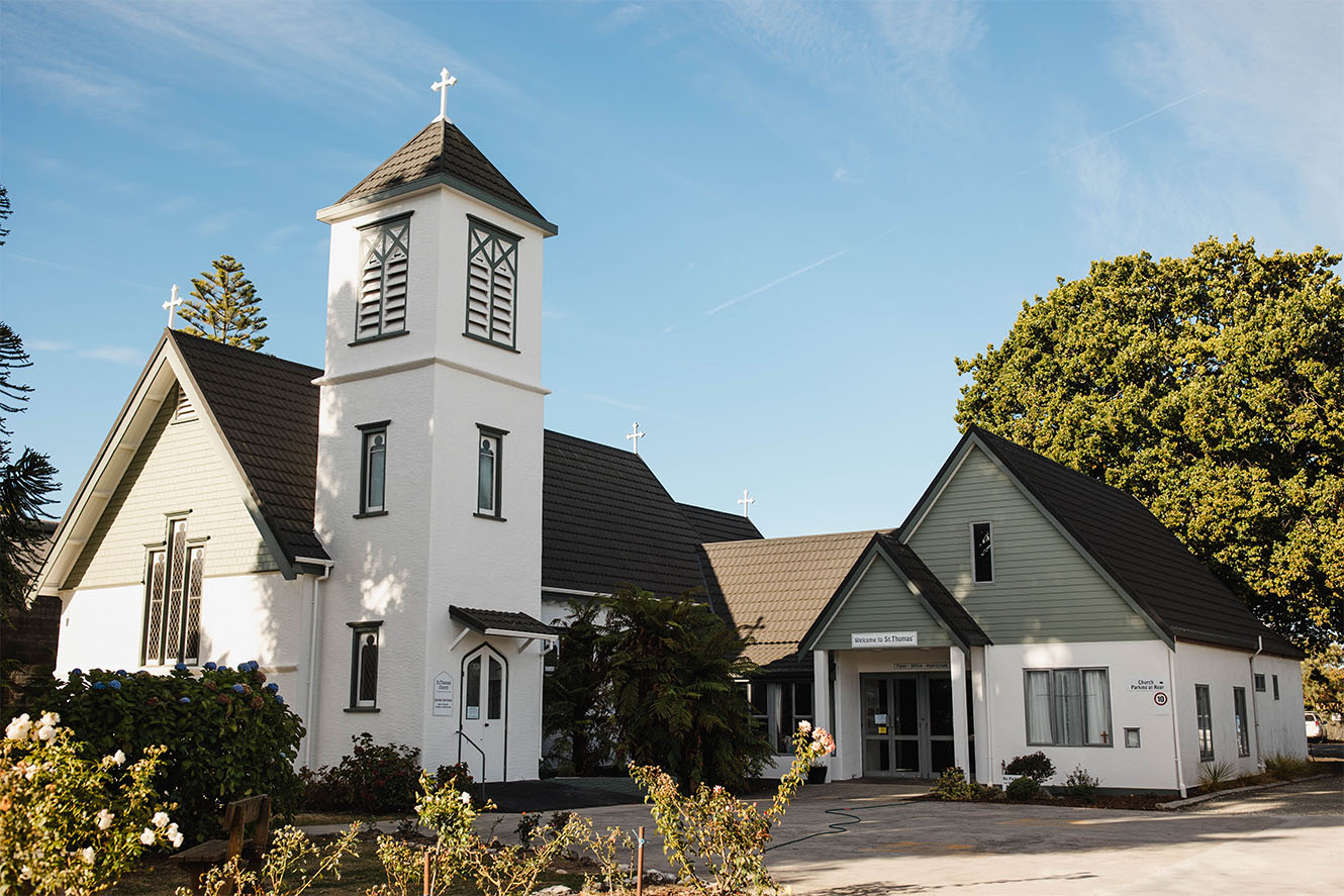 St Thomas' of Motueka Parish in the Nelson Anglican Diocese. a traditional white church building with green accents and a tall bell tower