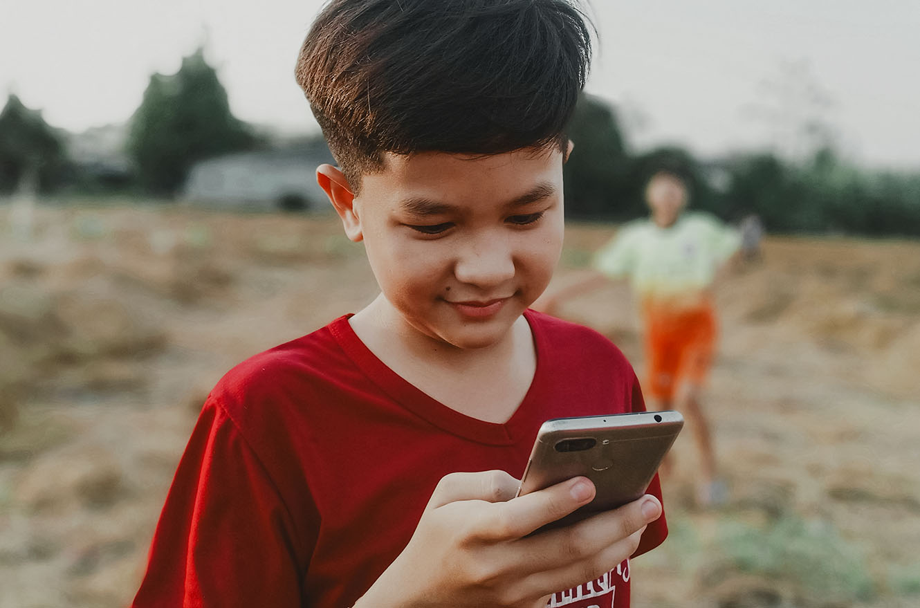 A child using a smartphone outside